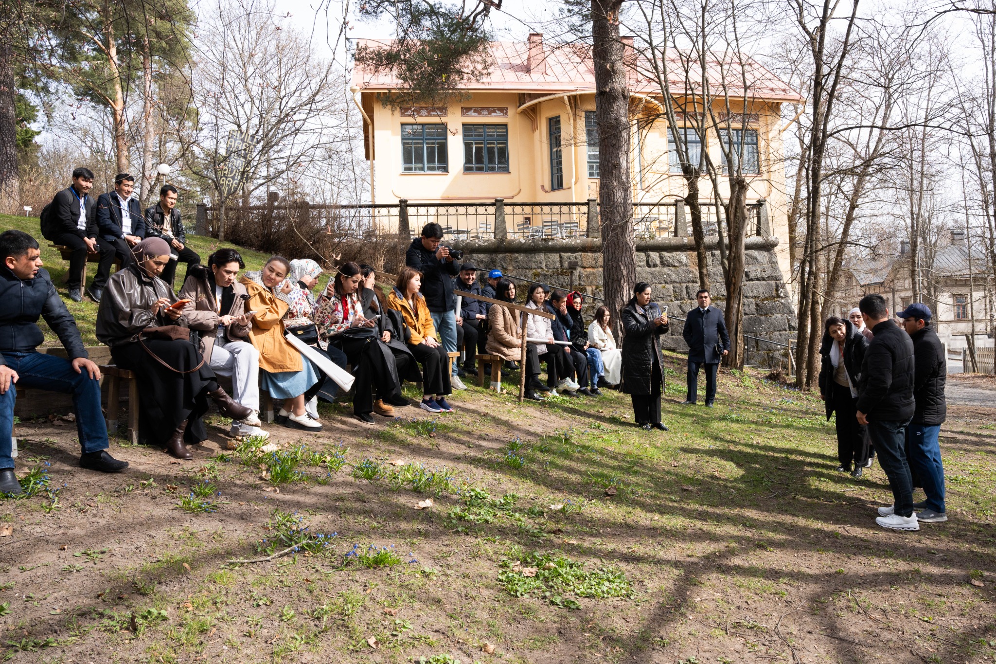 International educator group taking part in an outdoor discussion